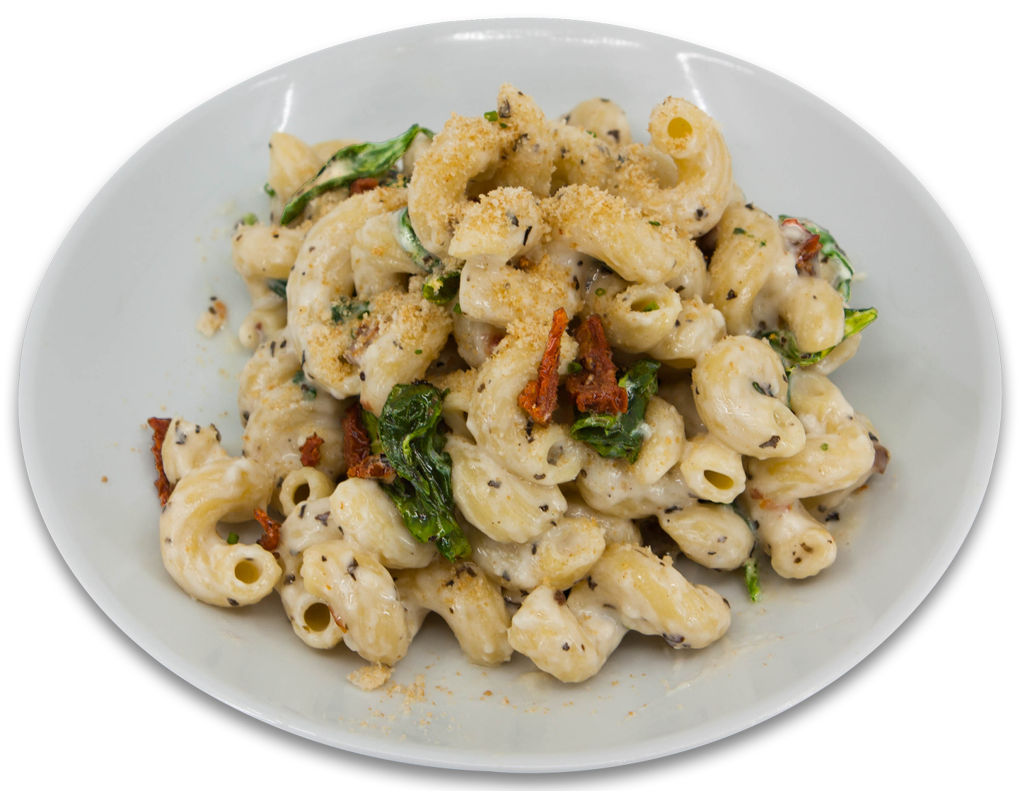 Macaroni au fromage avec tomates sechées et épinards